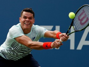 Milos Raonic returns a shot to Ryan Harrison during their second-round match at the U.S. Open on Aug. 31.