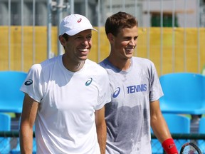 Daniel Nestor, left, and Vasek Pospisil during a pre-tournament workout in Rio. Remember when it was sunny?
