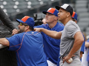 Mets hitting coach Kevin Long, left, newly acquired outfielder Jay Bruce, centre, and Yankees designated hitter Alex Rodriguez gather behind the batting cage during warmups before Tuesday's interleague game.