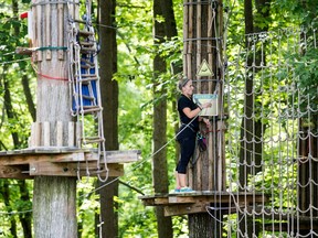 An employee closes up the Go Ape course for the day after a 59 year-old woman fell to her death at the zip line course in Lums Pond State Park in Bear, Del., Wednesday, Aug. 24, 2016.  Jeff Davis, a spokesman for Go Ape, said Thursday, Aug. 25, 2016, that the rides are inspected on a regular basis. Davis said the Lums Pond attraction is closed for undetermined amount of time to help with the investigation.