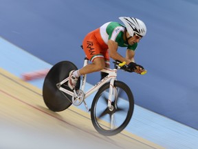 In this Aug. 31, 2012 file photo, Iranian cyclist Bahman Golbarnezhad races in the men's individual C4-5 one-kilometre cycling time trial final at the London Paralympics.
