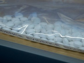 Fake Oxycontin pills containing fentanyl are displayed during a news conference at RCMP headquarters in Surrey, B.C., on September 3, 2015. Canada's plans to restrict six chemicals used to make fentanyl will only increase demands for a more dangerous replacement if other steps to stem a national opioid crisis are not taken, a drug-policy expert says.