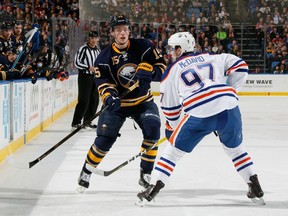 Jack Eichel (left) flips the puck by Connor McDavid during a Buffalo Sabres-Edmonton Oilers game on March 1.