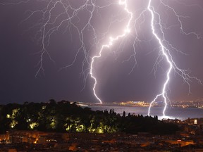 Flashes of lightning strike above the "Baie des Anges", on October 4, 2013, in Nice, southeastern France. One of the world's longest lightning strikes struck the country in 2012 and lasted over seven seconds.