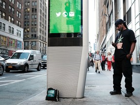 A man uses one of the new Wi-Fi kiosks that offer free web surfing, phone calls and a charging station on August 24, 2016 in New York City.