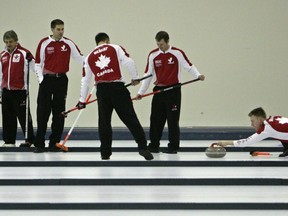 Brier Champion skip Kevin Martin, coach Jules Owchar, third John Morris, lead Ben Hebert and alternate Adam Enright look on as second Marc Kennedy delivers a rock during practice at the Saville Sports Centre in Edmonton, Alta., on in Edmonton, Alta., on Wednesday April 2, 2008.