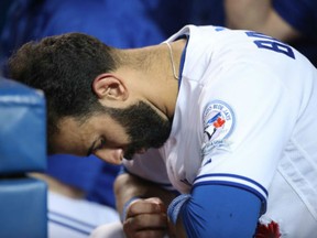 Jose Bautista of the Toronto Blue Jays reacts as he sits in the dugout during a 6-2 loss against the Tampa Bay Rays on Tuesday at Rogers Centre in Toronto.