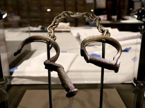 A pair of slave shackles are on display in the Slavery and Freedom Gallery in the Smithsonian's National Museum of African American History and Culture during the press preview on the National Mall September 14, 2016 in Washington, DC.