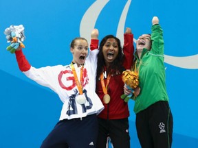 From left: Great Britain's Claire Cashmore, Canada's Katarina Roxon and Ireland's Ellen Keane celebrate on the podium at the medal ceremony for the women's 100m breaststroke - SB8 in Rio on Sept. 14.