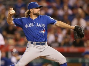 R.A. Dickey of the Toronto Blue Jays throws a pitch in the first inning against the Los Angeles Angels at Angel Stadium of Anaheim on Friday night in Anaheim, Calif.