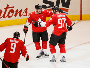 Canada's Joe Thornton (right) celebrates his second-period goal against the Czech Republic with Sidney Crosby (centre) on Sept. 17.