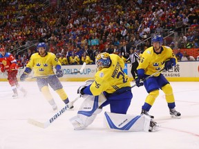 Swedish goaltender Jacob Markstrom (centre) shoots the puck out of his zone in Sweden's 2-1 win over Russia on Sept. 18.