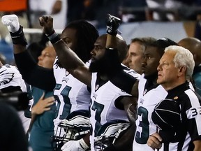 Philadelphia Eagles players hold up a salute during the national anthem prior to the game against the Chicago Bears at Soldier Field on September 19, 2016 in Chicago, Illinois.