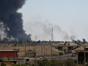 Smoke billowing over Qayyarah in late August. The Qayyarah Airfield West is 20 kilometres west of the town.
