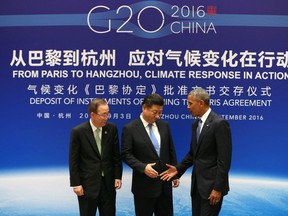 Chinese President Xi Jinping (C), US President Barack Obama (R) and UN Secretary General Ban Ki-moon shake hands during a joint ratification of the Paris climate change agreement ceremony ahead of the G20 Summit at the West Lake State Guest House in Hangzhou on September 3, 2016.
