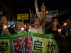 Protesters attend a candle light vigile for the southern Chinese village of Wukan outside the Chinese Liason Office in Hong Kong on September 17, 2017.
