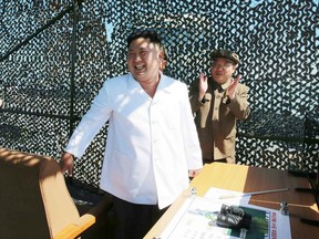 This undated picture released from North Korea's official Korean Central News Agency (KCNA) on September 20, 2016 shows North Korean leader Kim Jong-Un (C) inspecting the ground jet test of a new type high-power engine of a carrier rocket for the geo-stationary satellite at the Sohae Space Center in North Korea.
North Korea has successfully tested a new, high-powered rocket engine, state media said, a move Seoul said was designed to showcase its progress towards being able to target the US east coast.