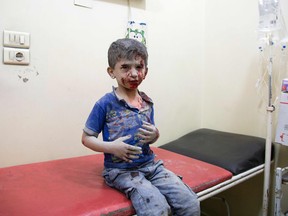 A Syrian boy awaits treatment at a make-shift hospital following air strikes on rebel-held eastern areas of Aleppo on Saturday.