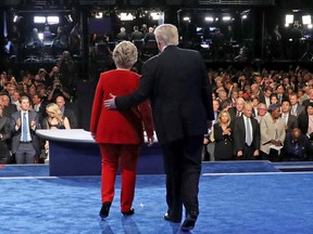 Democratic nominee Hillary Clinton (L) and Republican nominee Donald Trump greet the audience at the end of the first presidential debate at Hofstra University in Hempstead, New York.