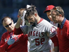Los Angeles Angels starting pitcher Matt Shoemaker is assisted off the field after being hit by a line drive from Seattle Mariners' Kyle Seager in the second inning of a baseball game, Sunday, Sept. 4, 2016, in Seattle.