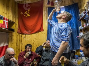 Russian and Chilean researchers drink homemade vodka at the Bellingshausen Station on King George Island in Antarctica, Nov. 28, 2015. Antarctica is a vast place, nearly twice the size of Australia, but it has no permanent population and sovereignty is a muddle, making criminal cases there difficult to handle.