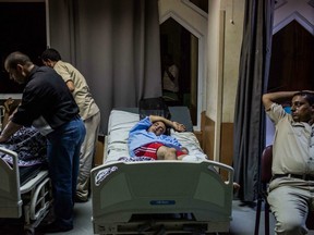 Mahmoud Abd el-Latif, an Egyptian man, sleeps at a hospital in Rosetta, Egypt, after rescued from a boat capsized off the Mediterranean coast near the Egyptian city of Alexandria, Wednesday, Sept. 21, 2016.