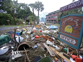 A street is blocked from debris washed up from the tidal surge of Hurricane Hermine Friday, Sept. 2, 2016, in Cedar Key, Fla