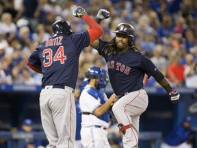 Boston Red Sox first baseman Hanley Ramirez celebrates his seventh-inning three-run homer with teammate David Ortiz during the Red Sox 13-3 win in Toronto, Friday.