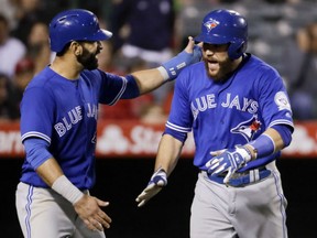Toronto Blue Jays' Russell Martin, right, celebrates after his three-run home run with Jose Bautista during the sixth inning against the Los Angeles Angels in Anaheim, Calif., Thursday.