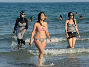 Canadian women should have the right to sport bikinis or burqinis, Ashley Csanady writes, if an all-Muslim community would threaten that, it should not be allowed.