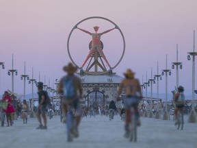 In this Wednesday, Aug. 31, 2016 photo, the Burning Man effigy, modeled after the Leonardo da Vinci's Vitruvian Man, stands above the playa during Burning Man at the Black Rock Desert north of Reno, Nev.