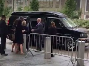 In the video, Clinton stumbles before entering the van