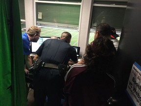 Sgt. Mike Pallotto of the Ventura College police department reviews game footage to determine whether a Mt. St. Antonio College player punched a referee during a community college football game in Ventura, Calif. on Saturday night.