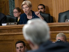 Sen. Elizabeth Warren questions Wells Fargo CEO John Stumpf, foreground, on Capitol Hill Tuesday,.
