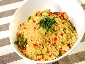 An ear of corn and garlic cloves are cooked on the barbecue together in foil to make Couscous with Grilled Corn.