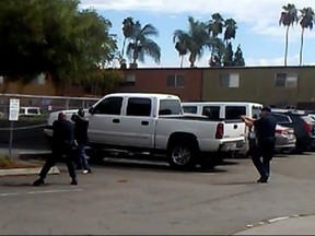 This video still shows the man who was shot standing near a pickup truck, assuming what police call a 'shooting stance.'