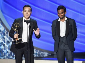 Aziz Ansari and writer Alan Yang accept Outstanding Writing for a Comedy Series for the 'Master of None' episode 'Parents' onstage during the 68th Annual Primetime Emmy Awards at Microsoft Theater on September 18, 2016 in Los Angeles, California.