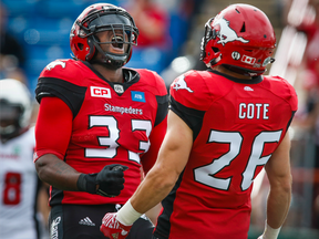Calgary's Jerome Messam, left, celebrates his first-half touchdown with teammate Rob Cote during their Sept. 17 game against the Ottawa Redblacks.