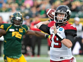 Calgary quarterback Bo Levi Mitchell (right) passes during his team's 34-28 win over Edmonton on Sept. 10.