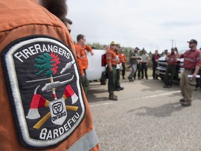 Researchers at the University of Regina say there's a such a mishmash of programs aimed at helping first responders cope with stress that it's tough to know if any are working. Firefighters from Ontario are briefed prior to heading into Fort McMurray, Alta., south of the city on highway 63, in a May 7, 2016, file photo.