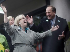 Federal Green Party leader Elizabeth May and B.C. Green Party leader Andrew Weaver brave the elements to wave at traffic and speak to people in Victoria in 2013.