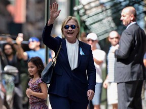 US Democratic presidential nominee Hillary Clinton waves to the press as she leaves her daughter's apartment building after resting on September 11, 2016, in New York.