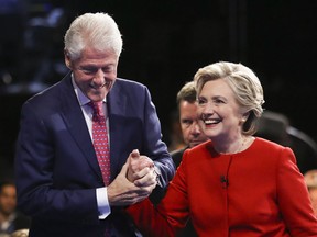 Democratic presidential nominee Hillary Clinton walks off the stage with her husband former President Bill Clinton after the presidential debate with Republican presidential nominee Donald Trump at Hofstra University in Hempstead, N.Y., Monday, Sept. 26.