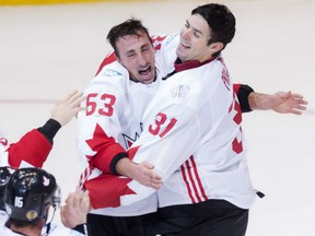 Team Canada forward Brad Marchand, left, celebrates with teammate Carey Price  after beating Team Europe 2-1 in Game 2 to claim the World Cup of Hockey in Toronto on Thursday.