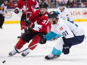 Team Canada centre Sidney Crosby battles for the puck against Europe centre Frans Nielsen during the third period of Canada's 3-1 win in game 1 of the World Cup of Hockey best-of-three final in Toronto, Tuesday.