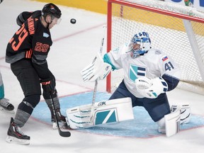 Team North America's Nathan MacKinnon (left) eyes the puck in front of European goaltender Jaroslav Halak during their Sept. 11 exhibition game in Montreal.