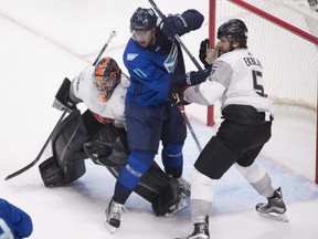 Team Europe's Anze Kopitar, centre, is pushed by Team North America's Aaron Ekblad as he stands in goalie Matt Murray's crease during the second period of a World Cup of Hockey pre-tournament game Thursday night in Quebec City.