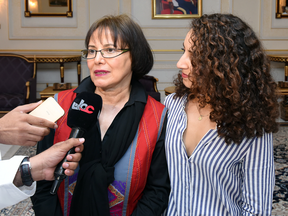 Retired Iranian-Canadian professor Homa Hoodfar, left, speaks to the media in Muscat airport, Oman, after being released by Iranian authorities, Monday, Sept. 26, 2016