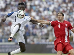 Honduras' Alberth Elis, left, and Canada's Dejan Jakovic battle for the ball during a World Cup qualifying match in San Pedro Sula, Honduras, on Friday. Honduras won 2-1.