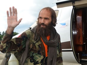 Freed Norwegian national Kjartan Sekkingstad waves as he prepares to board a plane at Jolo airport, in southern island of Mindanao, on Sept. 18, 2016, on his way to Davao City.